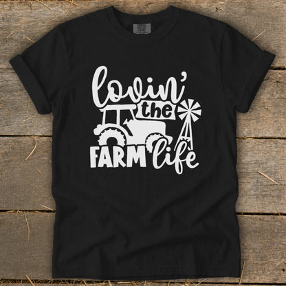 Black t-shirt with white graphic of tractor, windmill, and text "lovin' the FARM life".