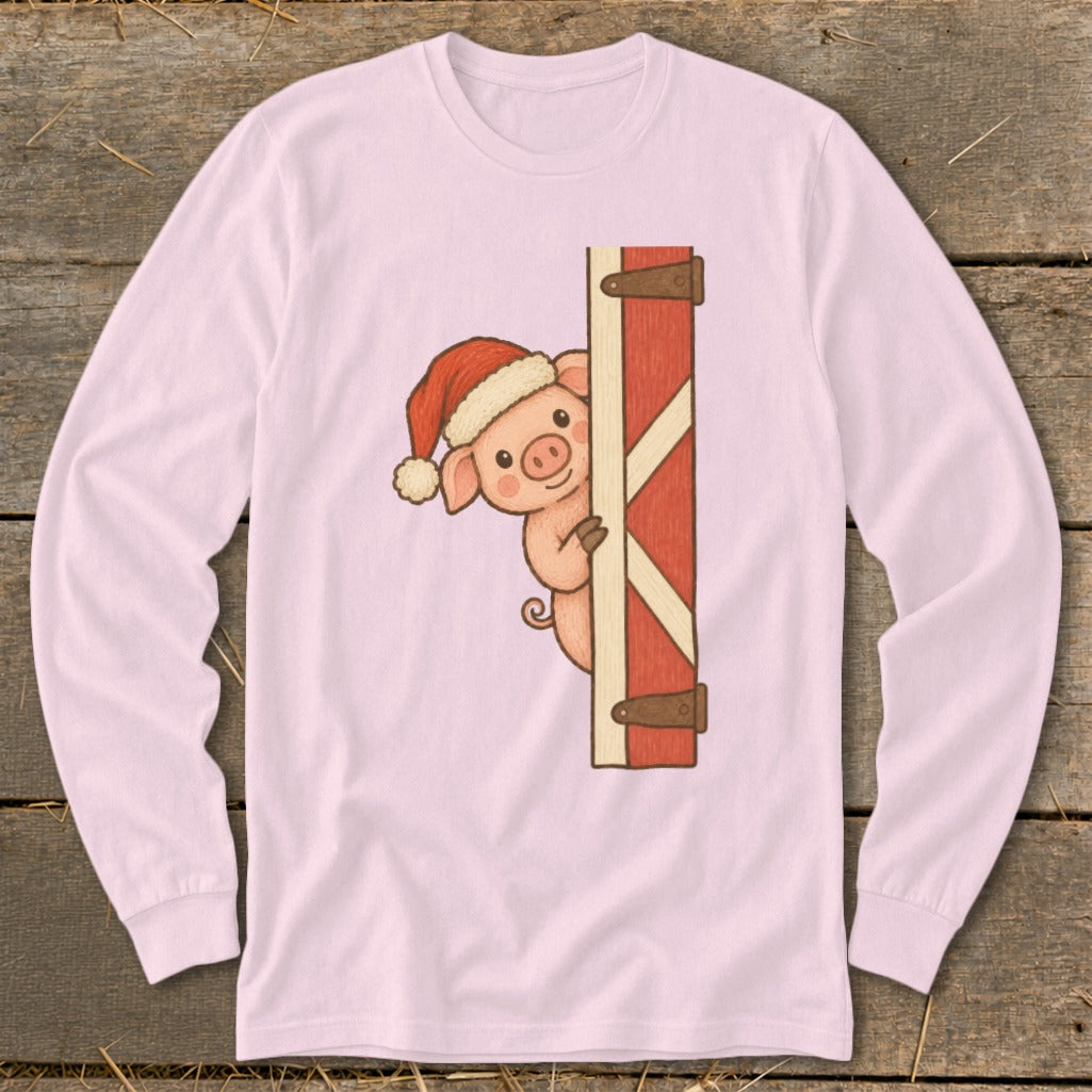 Pink long-sleeve shirt with a pig wearing a Santa hat peeking from behind a barn door.