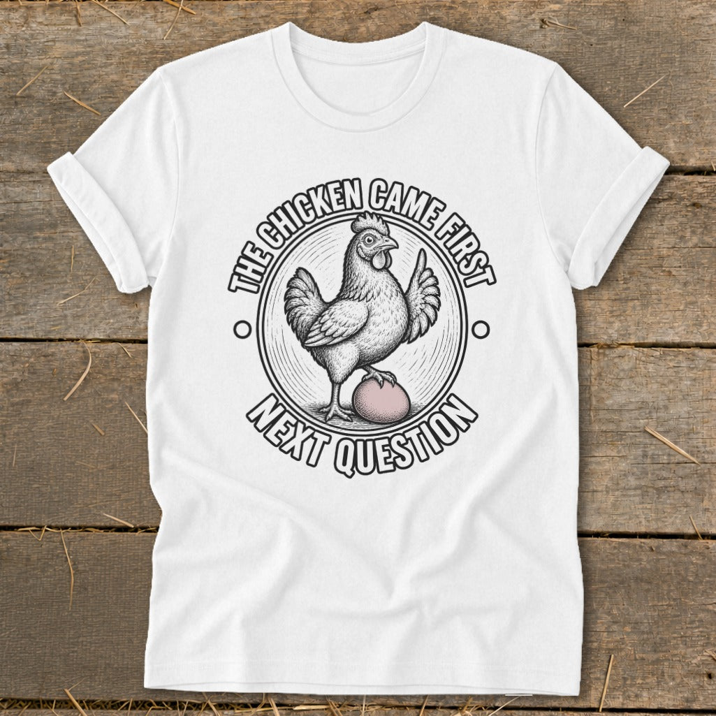 White t-shirt with a chicken and egg graphic and text "The chicken came first, next question".