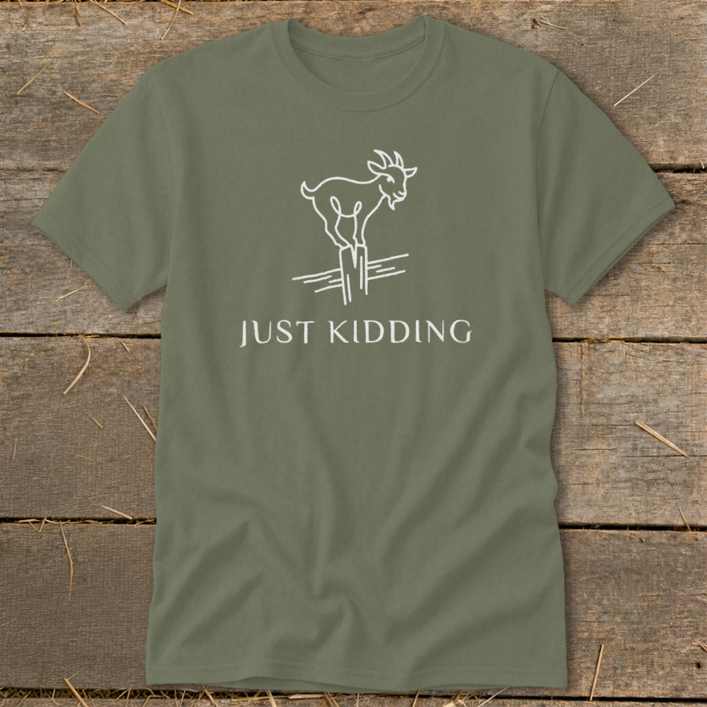 Olive green t-shirt with white line drawing of a goat on a fence and "JUST KIDDING" text.