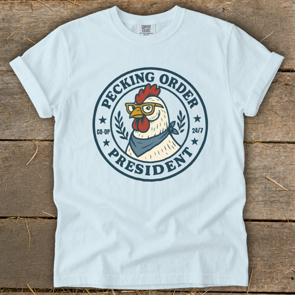 Light blue t-shirt with a chicken wearing glasses and a bandana, labeled "Pecking Order President".