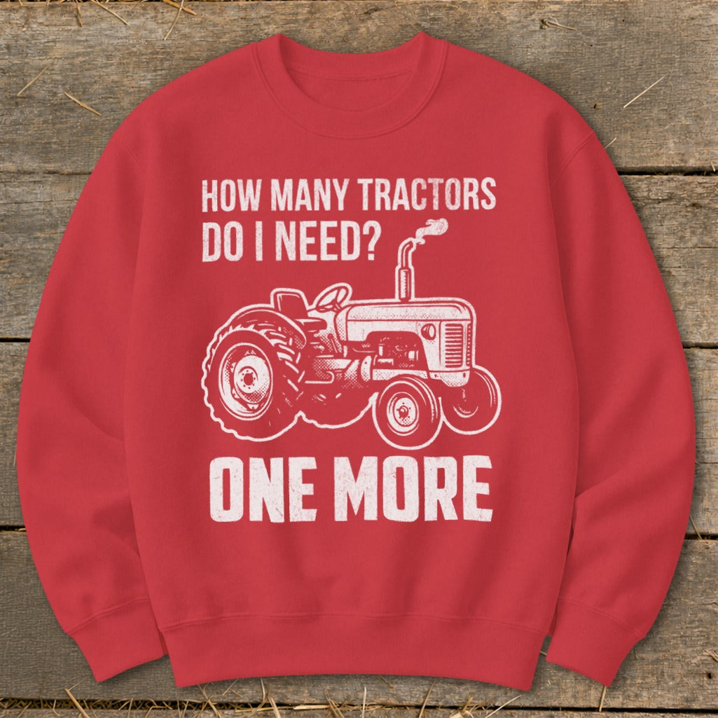 Red sweatshirt with white text "HOW MANY TRACTORS DO I NEED? ONE MORE" and tractor graphic.