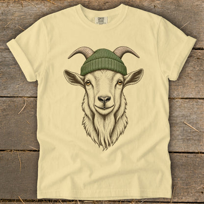 Cream t-shirt with a detailed illustration of a goat wearing a green beanie.