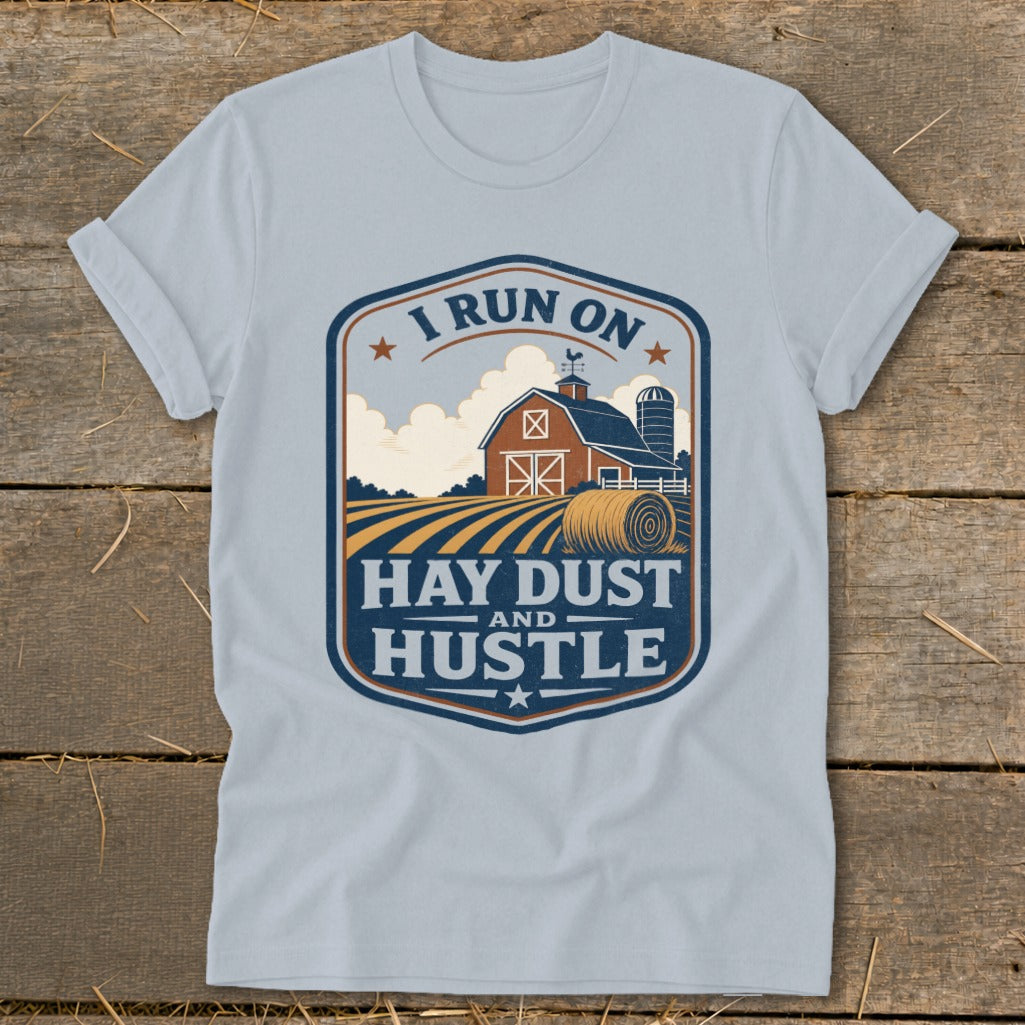 Light blue t-shirt with "I run on Hay Dust and Hustle" farm graphic.