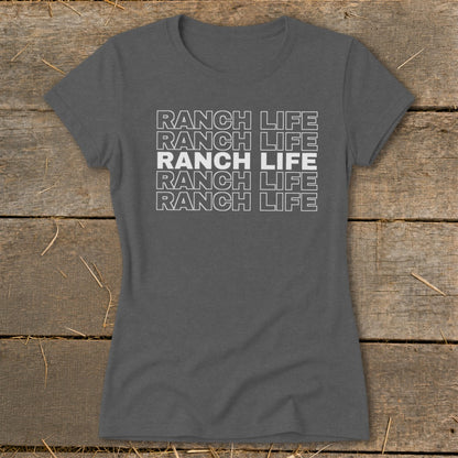 Dark gray women's t-shirt featuring stacked white text that reads RANCH LIFE on a rustic wooden background.