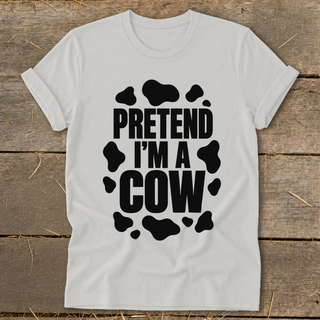 White t-shirt with black text reading "PRETEND I'M A COW" within cow spots.