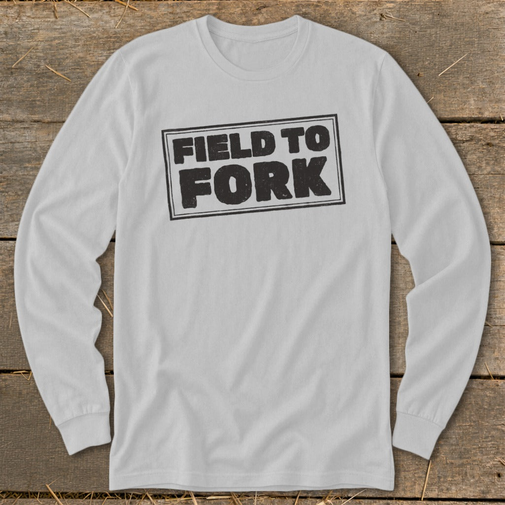 A light gray long-sleeve t-shirt with a distressed black box graphic reading "FIELD TO FORK" centered on the chest.