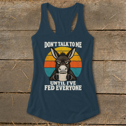 Dark blue racerback tank top with a retro graphic of a grumpy donkey drinking coffee.