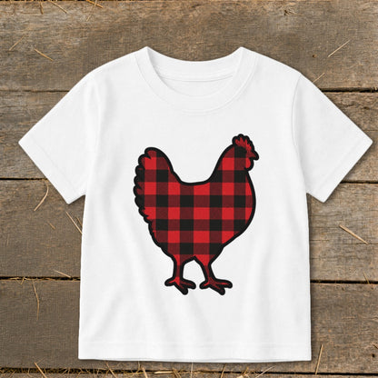 White t-shirt with a buffalo plaid chicken graphic on a wooden background.