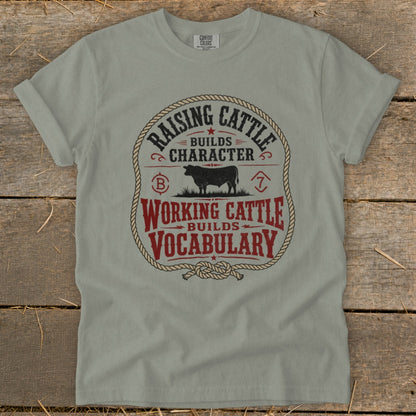 Gray t-shirt with "Raising Cattle Builds Character, Working Cattle Builds Vocabulary" graphic.