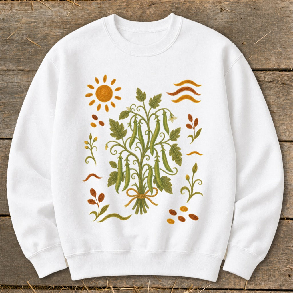 White sweatshirt with a green pea plant illustration and sun, leaves, and beans.