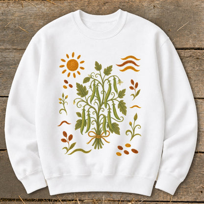 White sweatshirt with a green pea plant illustration and sun, leaves, and beans.