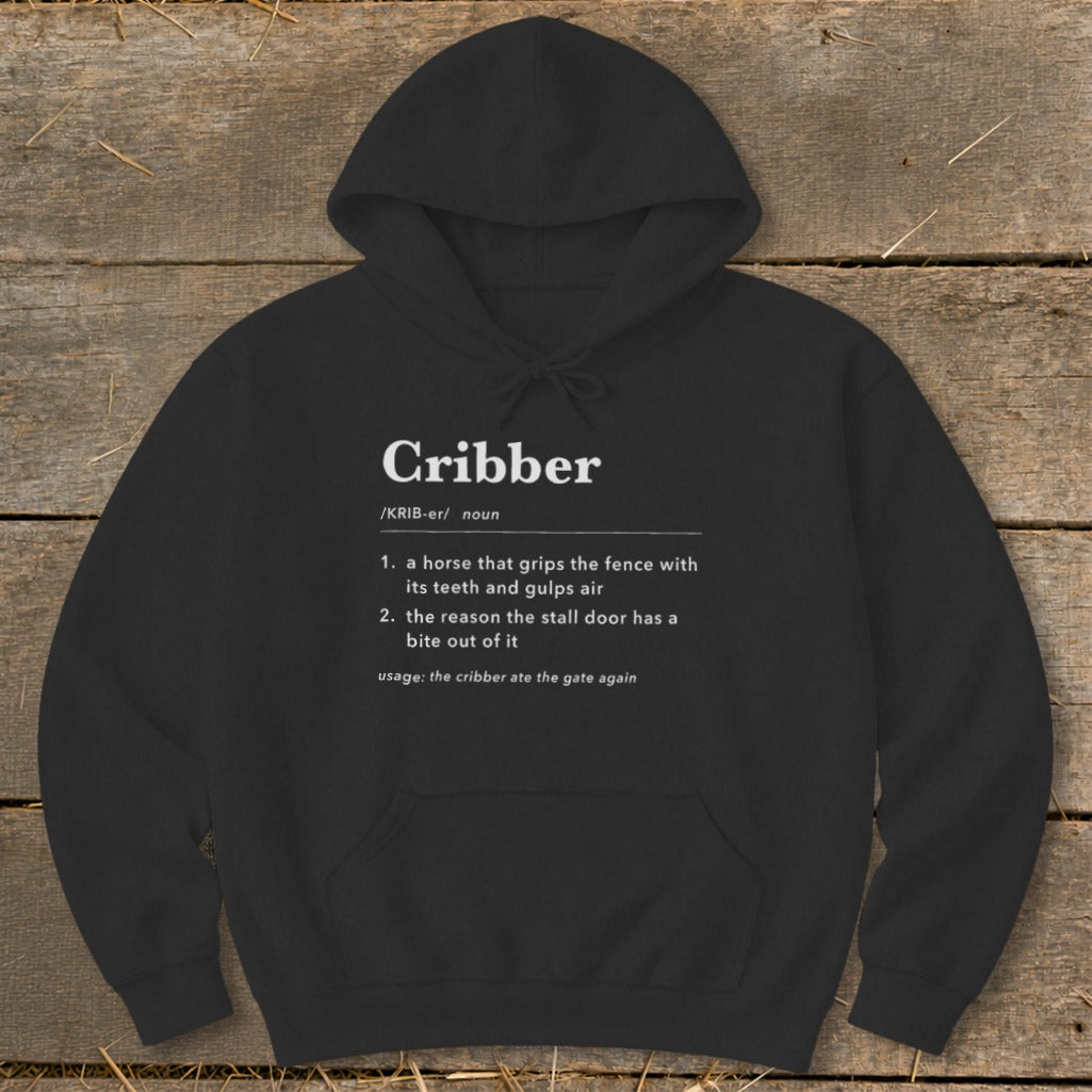 Black hooded sweatshirt featuring a humorous dictionary definition of the word cribber in white text.