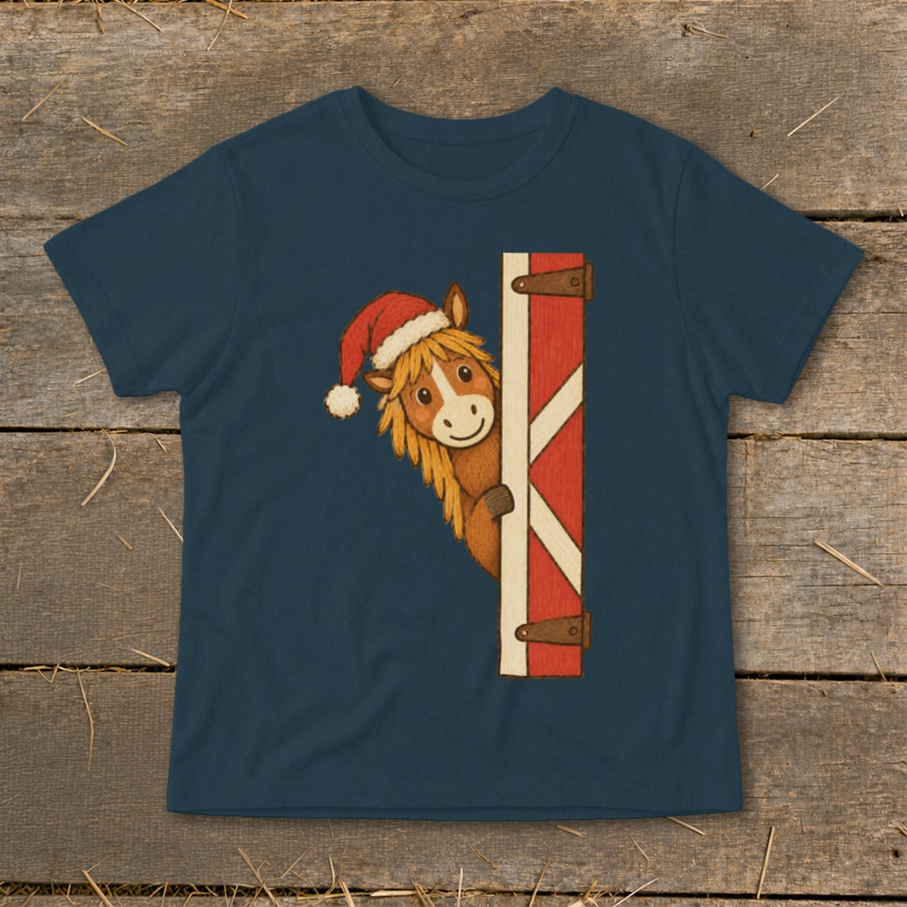 T-shirt with a horse wearing a Santa hat peeking from behind a red barn door.