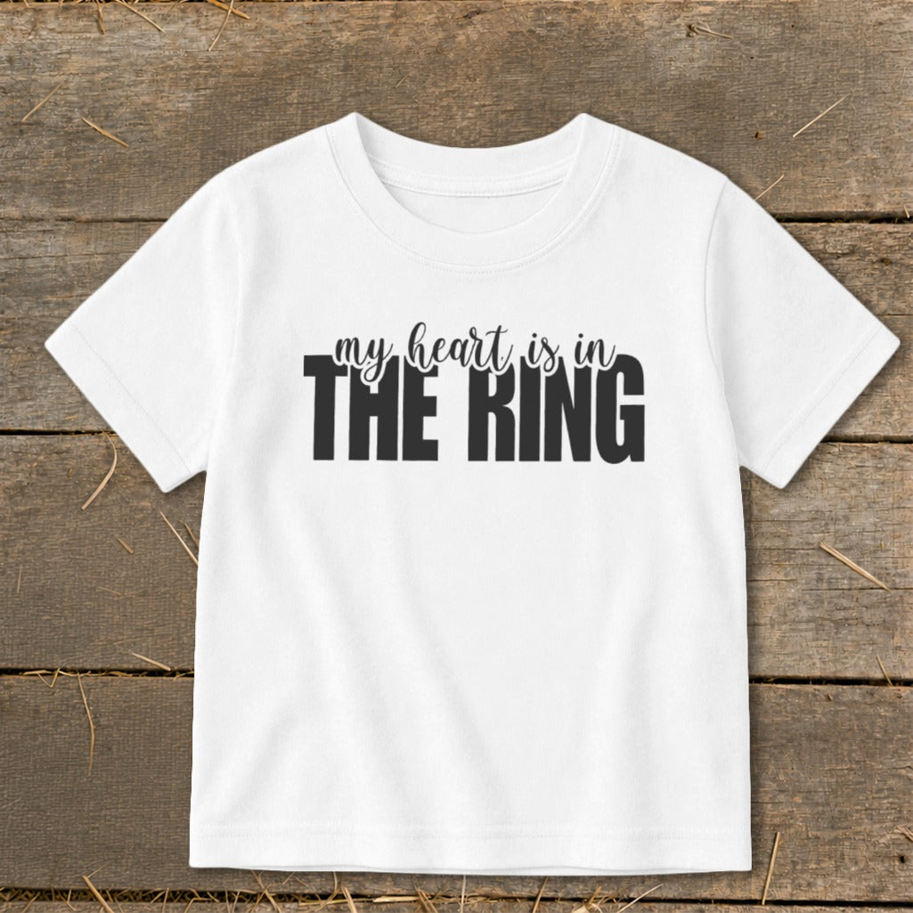 White t-shirt with black text that reads "my heart is in THE RING".