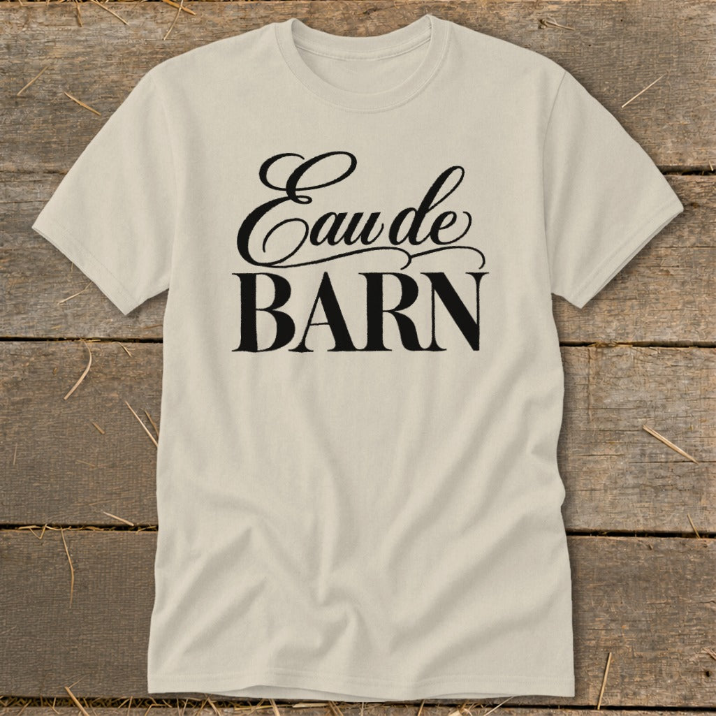 Cream t-shirt with "Eau de BARN" text in black script and block letters.
