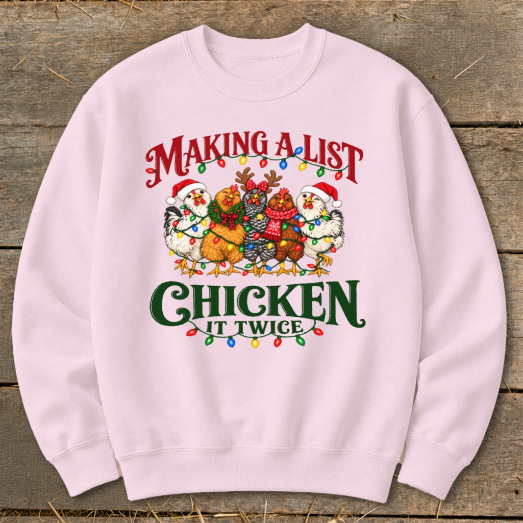Pink sweatshirt with chickens in Santa hats and Christmas lights, saying "Making a list, chicken it twice."