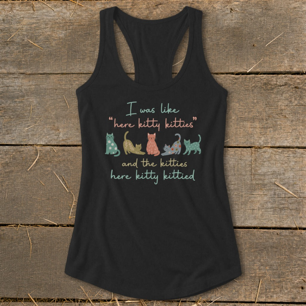 Black tank top with "I was like 'here kitty kitties' and the kitties here kitty kittied" and cat illustrations.