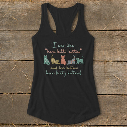 Black tank top with "I was like 'here kitty kitties' and the kitties here kitty kittied" and cat illustrations.