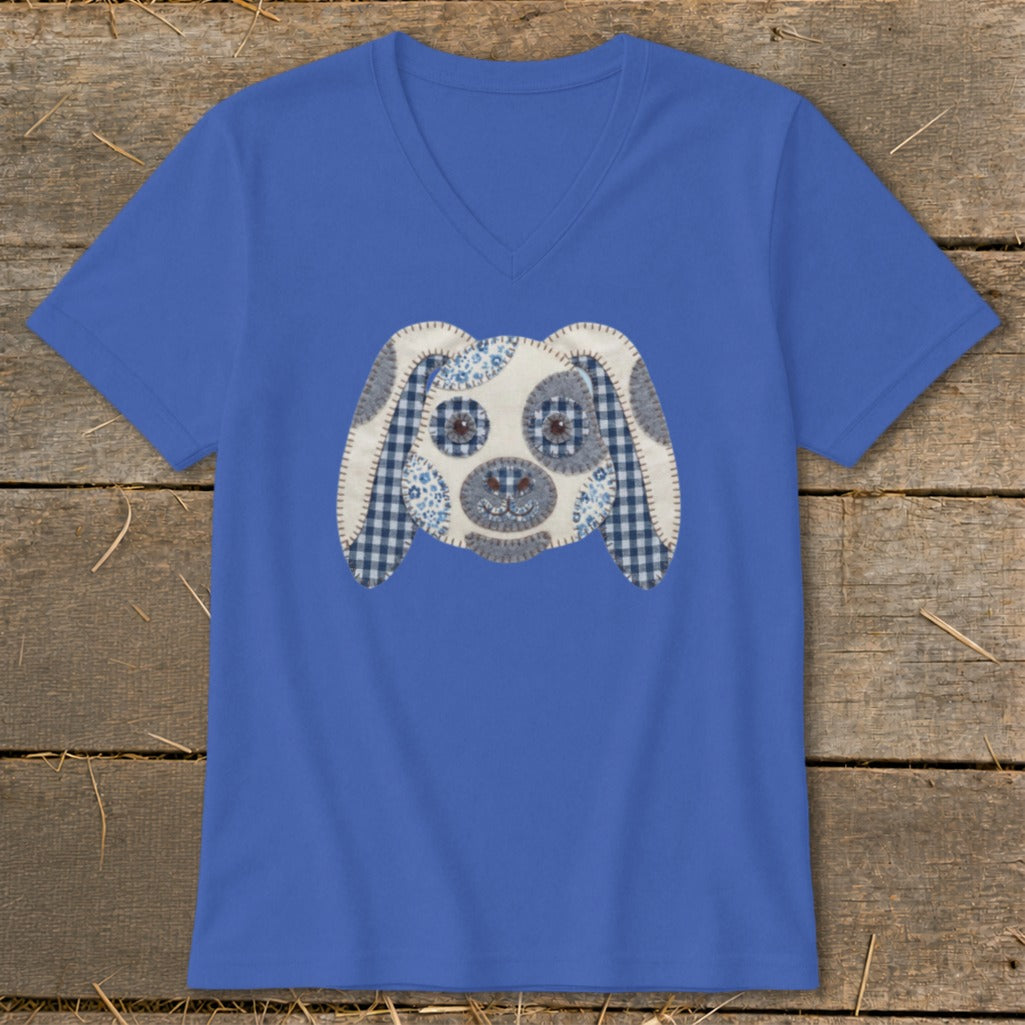 Blue v-neck t-shirt with a stuffed dog face applique featuring checkered and floral fabric.