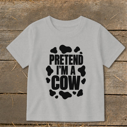Light grey t-shirt with black cow spots and text "PRETEND I'M A COW".