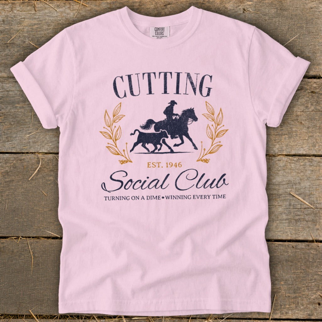 Pink t-shirt with "Cutting Social Club Est. 1946" graphic and cowboy on horse.