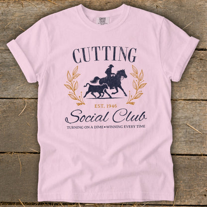 Pink t-shirt with "Cutting Social Club Est. 1946" graphic and cowboy on horse.
