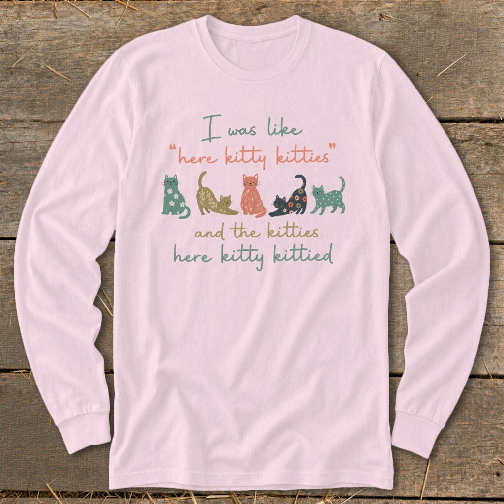 Pink long-sleeve shirt with "I was like 'here kitty kitties' and the kitties here kitty kittied" text and cat graphics.