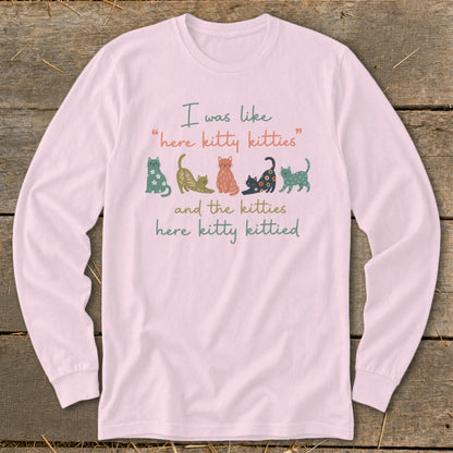 Pink long-sleeve shirt with "I was like 'here kitty kitties' and the kitties here kitty kittied" text and cat graphics.