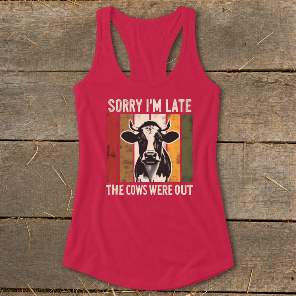 Pink tank top with cow graphic and text "SORRY I'M LATE THE COWS WERE OUT".