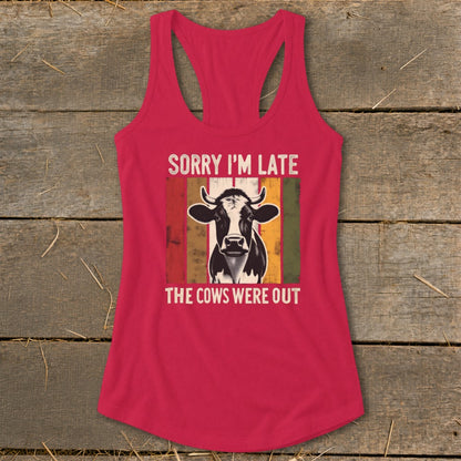 Pink tank top with cow graphic and text "SORRY I'M LATE THE COWS WERE OUT".