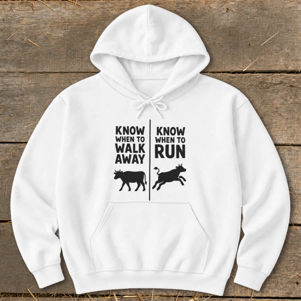 White hoodie with text and silhouette of a cow walking and running.