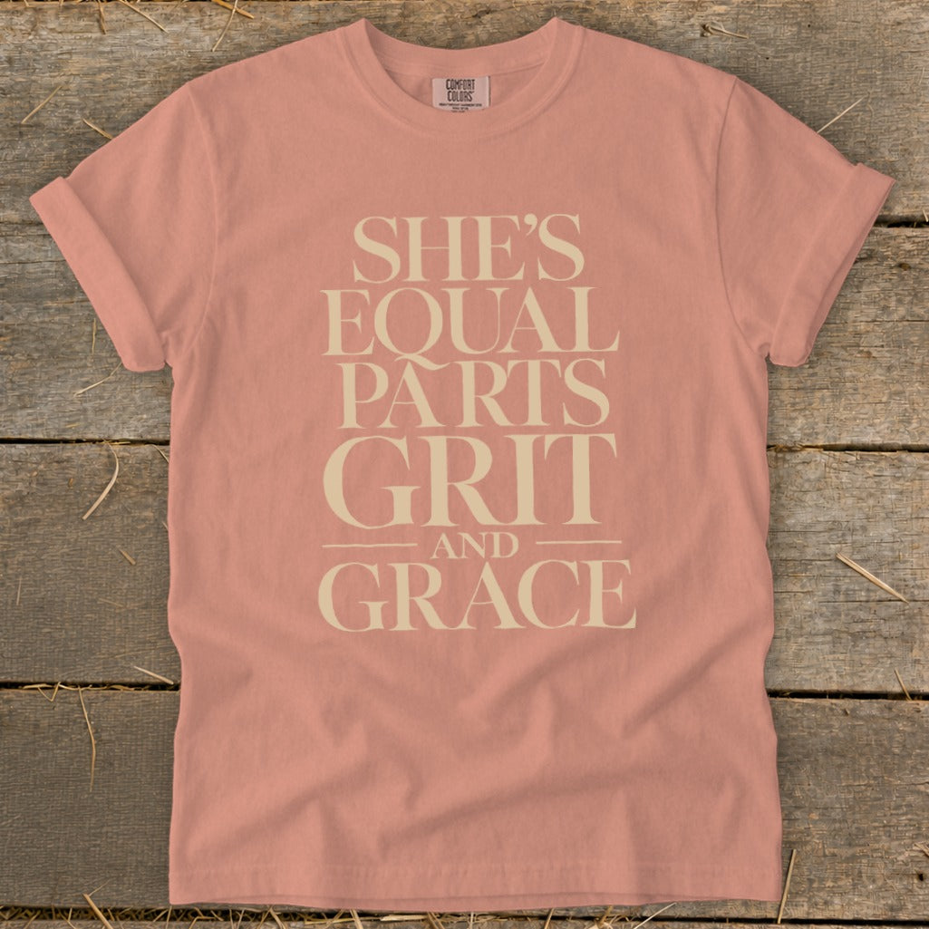 Peach Comfort Colors t-shirt with "She's Equal Parts Grit and Grace" text.