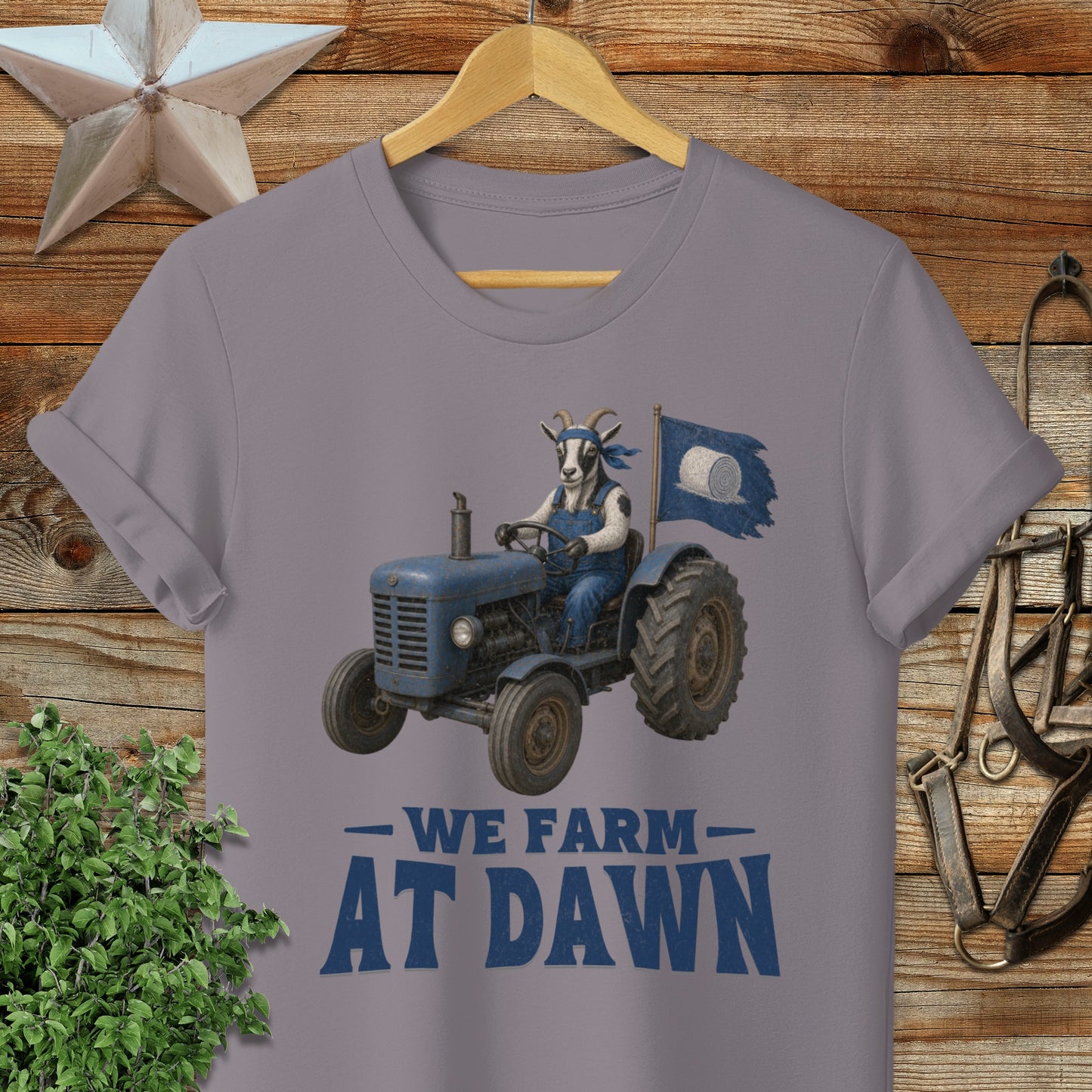 Goat driving a tractor with "WE FARM AT DAWN" text.