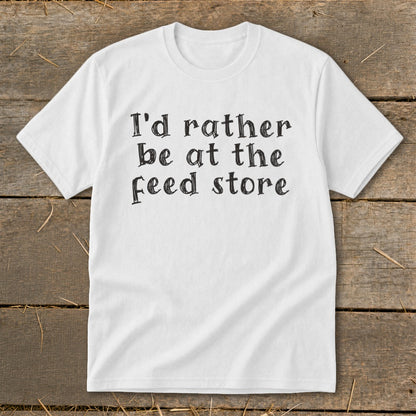 White t-shirt with black text "I'd rather be at the feed store".