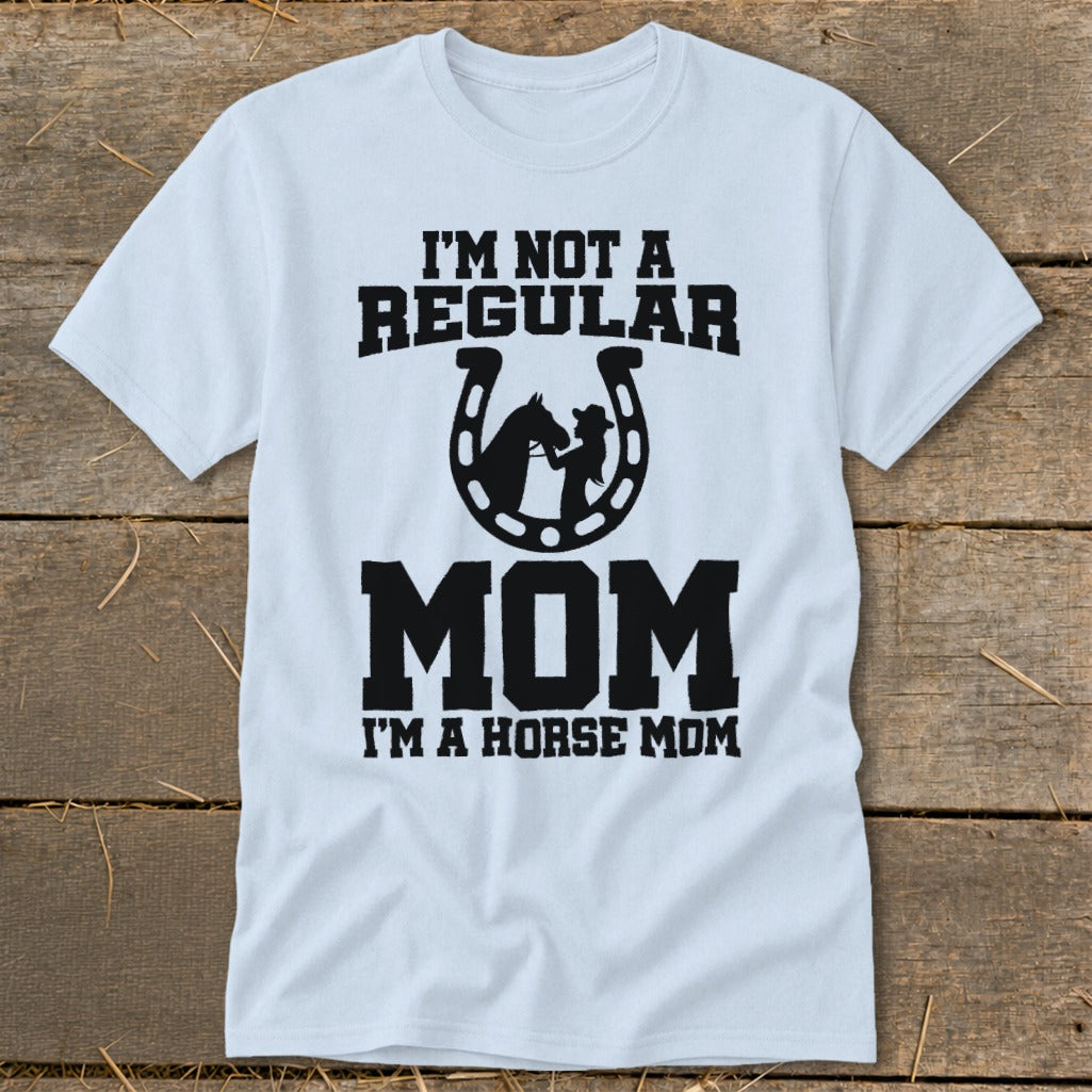 White t-shirt with black text reading "I'm Not a Regular Mom, I'm a Horse Mom" and a horseshoe graphic.
