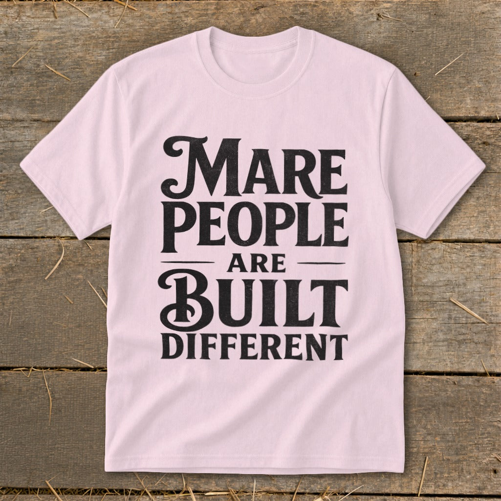 Light pink t-shirt with black text that reads "MARE PEOPLE ARE BUILT DIFFERENT".