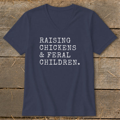 Navy v-neck t-shirt with white text reading "RAISING CHICKENS & FERAL CHILDREN."