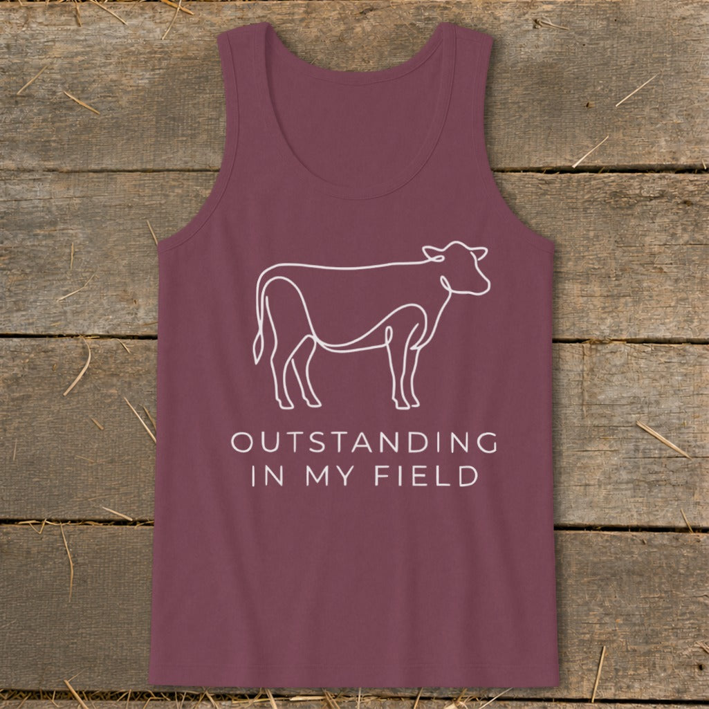 Maroon tank top with white line art cow and text "OUTSTANDING IN MY FIELD".
