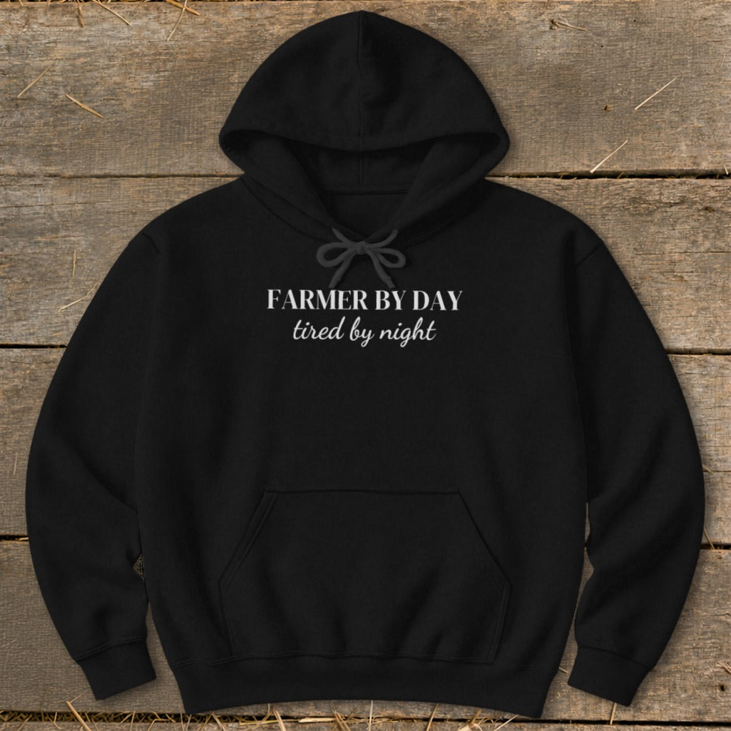 Black hoodie with white text "FARMER BY DAY tired by night".