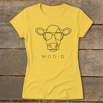 Yellow t-shirt with black line art of a cow wearing sunglasses and "MOO-D" text.