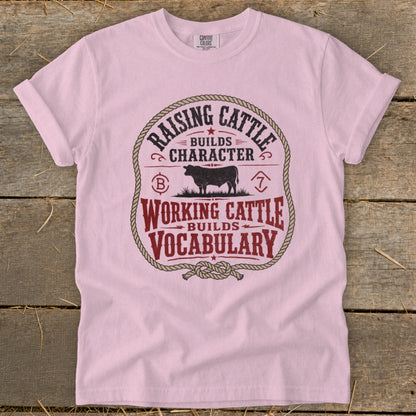 Pink t-shirt with "Raising Cattle Builds Character" and "Working Cattle Builds Vocabulary" text.