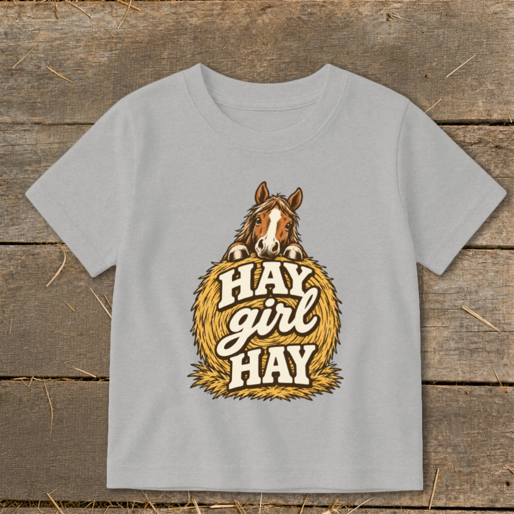 Grey t-shirt with a horse peeking over a hay bale with text "HAY girl HAY".