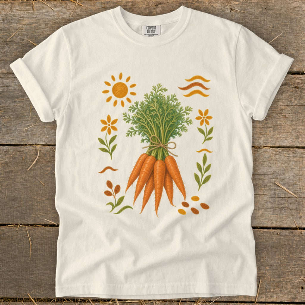 White t-shirt with a graphic of a bunch of carrots surrounded by stylized sun, flowers, and leaves.