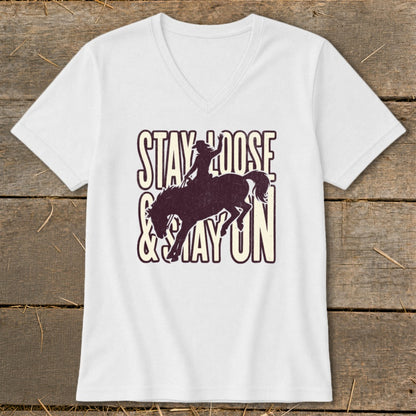 White V-neck t-shirt with "STAY LOOSE & STAY ON" text and rodeo rider silhouette.