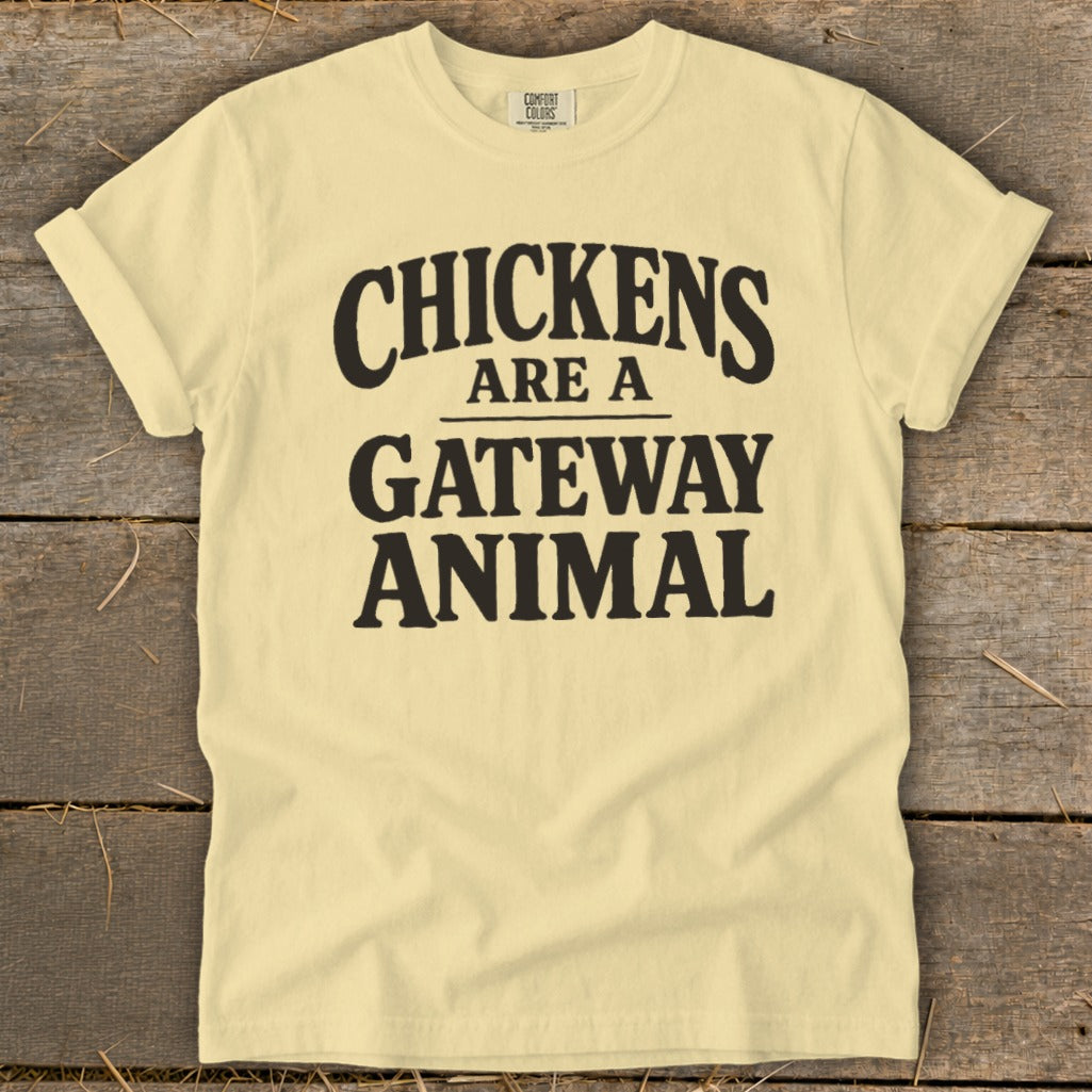Light yellow t-shirt with black text reading "CHICKENS ARE A GATEWAY ANIMAL."