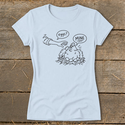 Light blue t-shirt with cartoon chicken protecting eggs, saying "MINE".