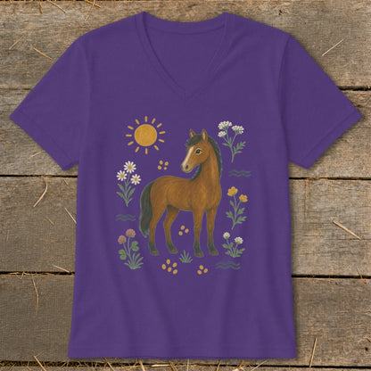 Purple t-shirt with a brown horse surrounded by a sun, flowers, and clover.