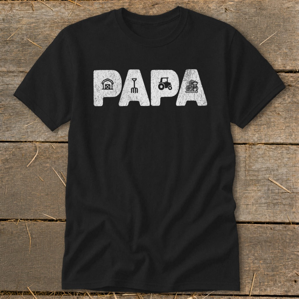 Black t-shirt with white "PAPA" text and farming icons: barn, pitchfork, tractor, corn.