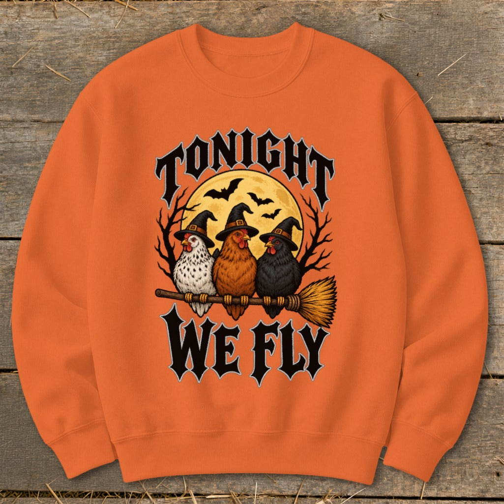 Three chickens in witch hats riding a broomstick under a full moon with text "TONIGHT WE FLY".